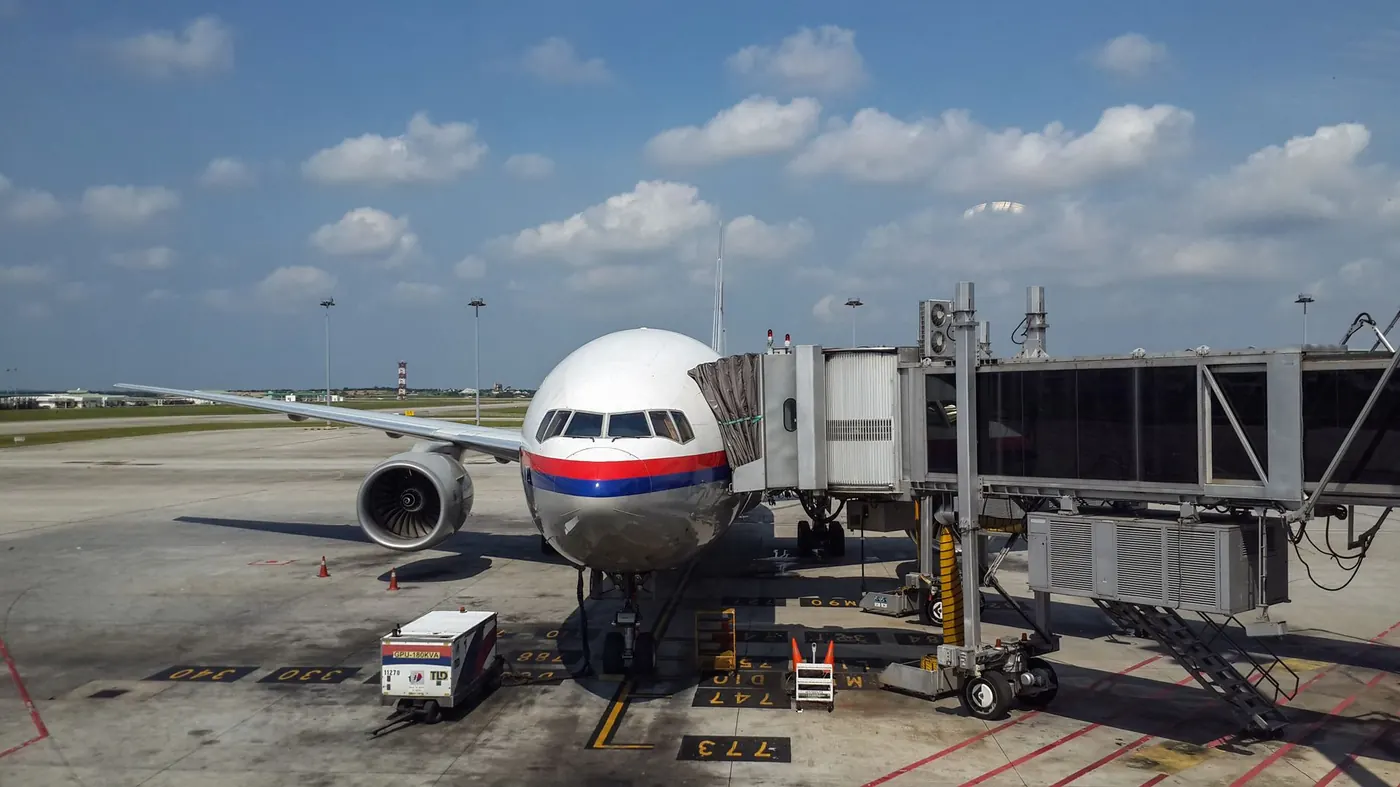 Travelers at an airport before flying to Malaysia